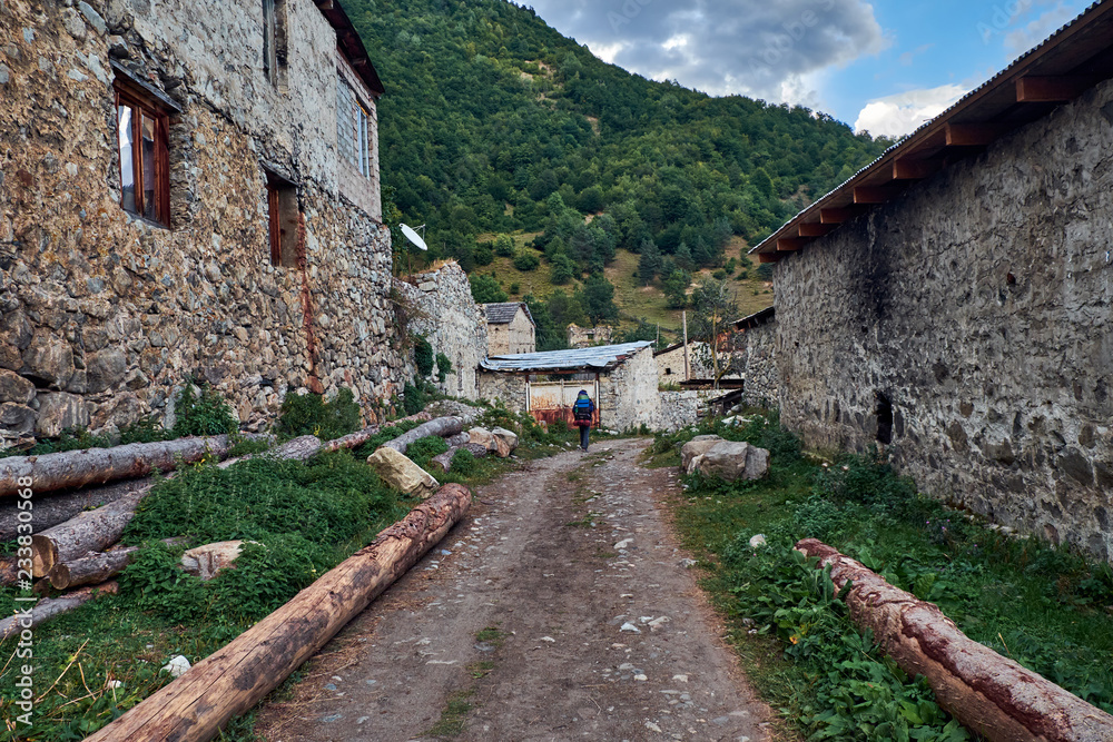 Tourist with backpack walking through the Maseri village Tourist with backpack walking through the Maseri village