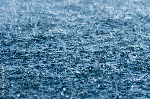 Falling rain drops, splash on water surface