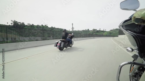 Harley Riders Cruising Down Street On Board