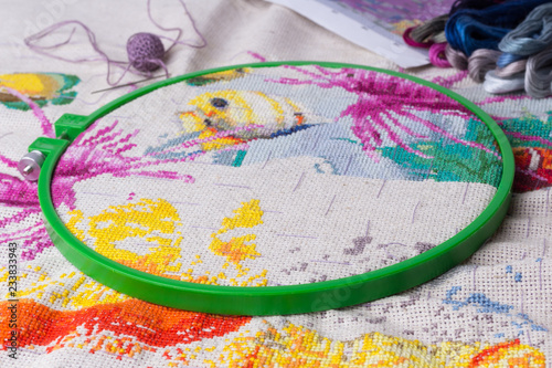 The process of working on a piece of embroidery.