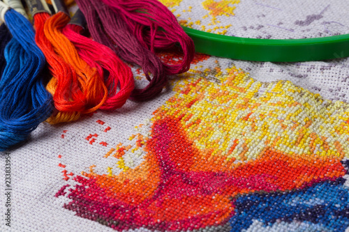 The process of working on a piece of embroidery.