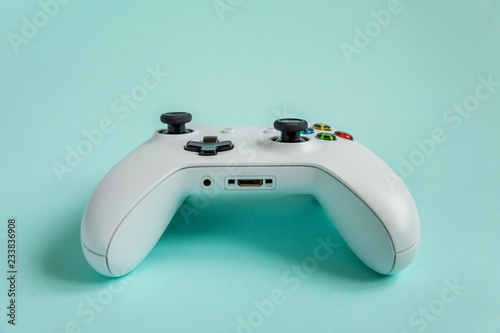White joystick gamepad, game console on blue colourful trendy modern fashion pin-up background. Computer gaming competition videogame control confrontation concept. Cyberspace symbol