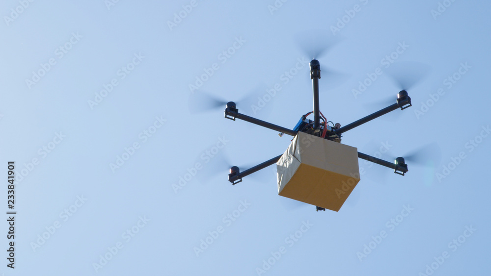 CLOSE UP: Futuristic package shipment by helicopter drone. Air cargo delivery CLOSE UP: Futuristic package shipment by helicopter drone. Air cargo delivery