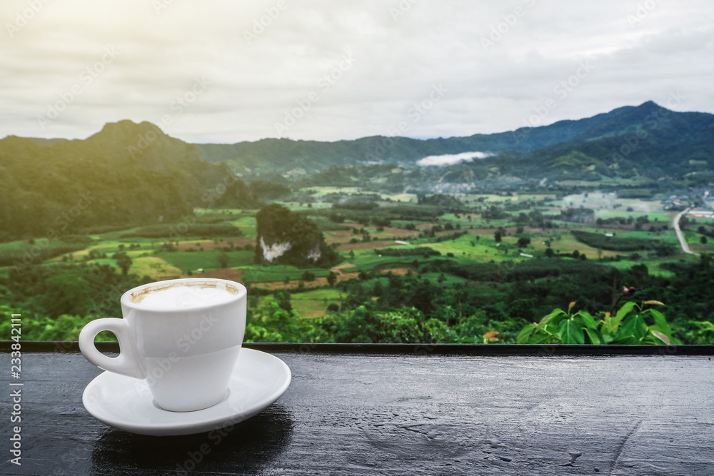 coffee cup on table with Mountain views in the morning as a background coffee cup on table with Mountain views in the morning as a background