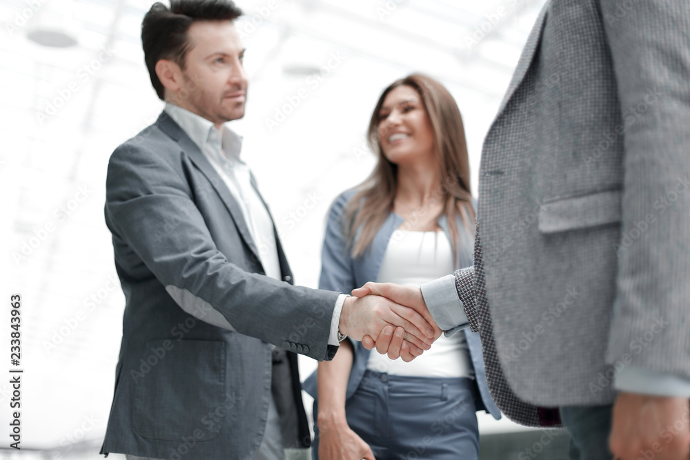 business people greet each other with a handshake