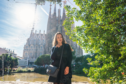 Photography beautiful girl posing behind amazing gothic basilica church in europe