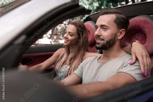 close up.a loving couple traveling in a convertible car
