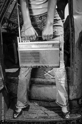 Retro girl with vintage radio in hands. Black and white