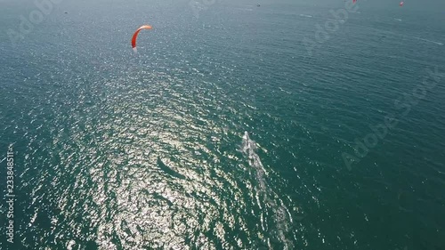 Aerial view over single para sail surfer travelling across the water.