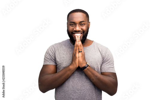Christian African-American believer prays to God and smiles, he folded his hands in a gesture of prayer. He is proud of his religion and adheres to the traditions of his faith. Righteous way photo