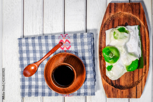 Badak berendam a local Malaysian dessert and cuf of coffee  on wooden background photo