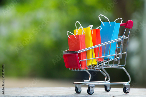 Colorful paper shopping bags in a trolley,E-commerce concept.