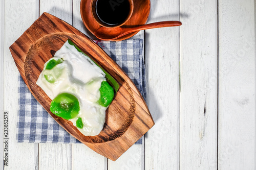 Badak berendam a local Malaysian dessert and cuf of coffee  on wooden background photo