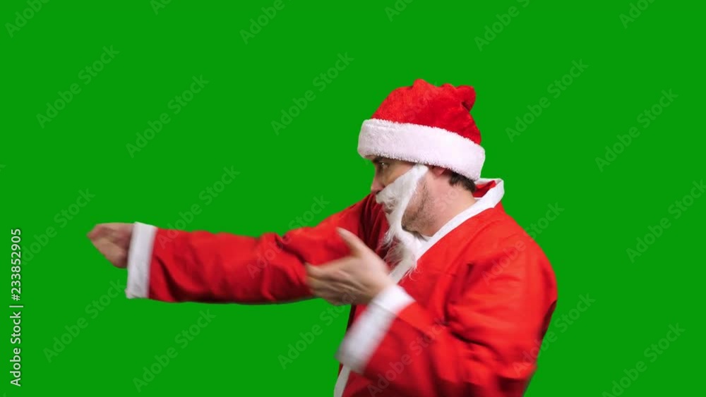 Santa Claus in red costume drag something on green chroma key background Santa Claus in red costume drag something on green chroma key background