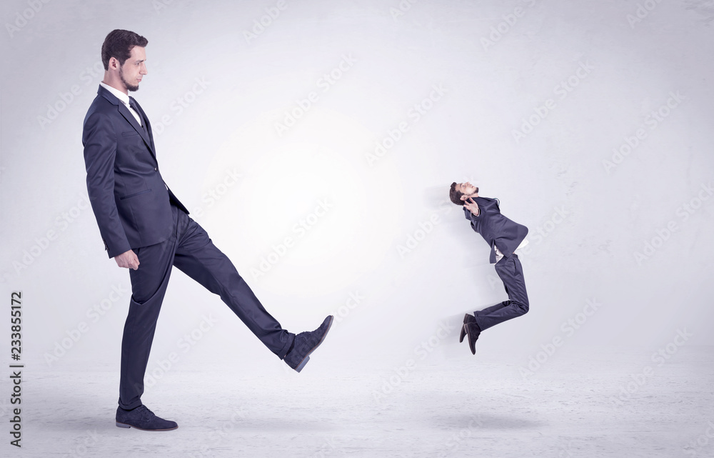 Big man in suit kicking out little himself out with simple white wallpaper
