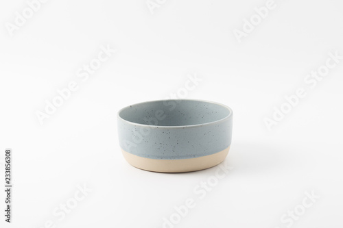 Blue empty ceramic bowl isolated on white background.