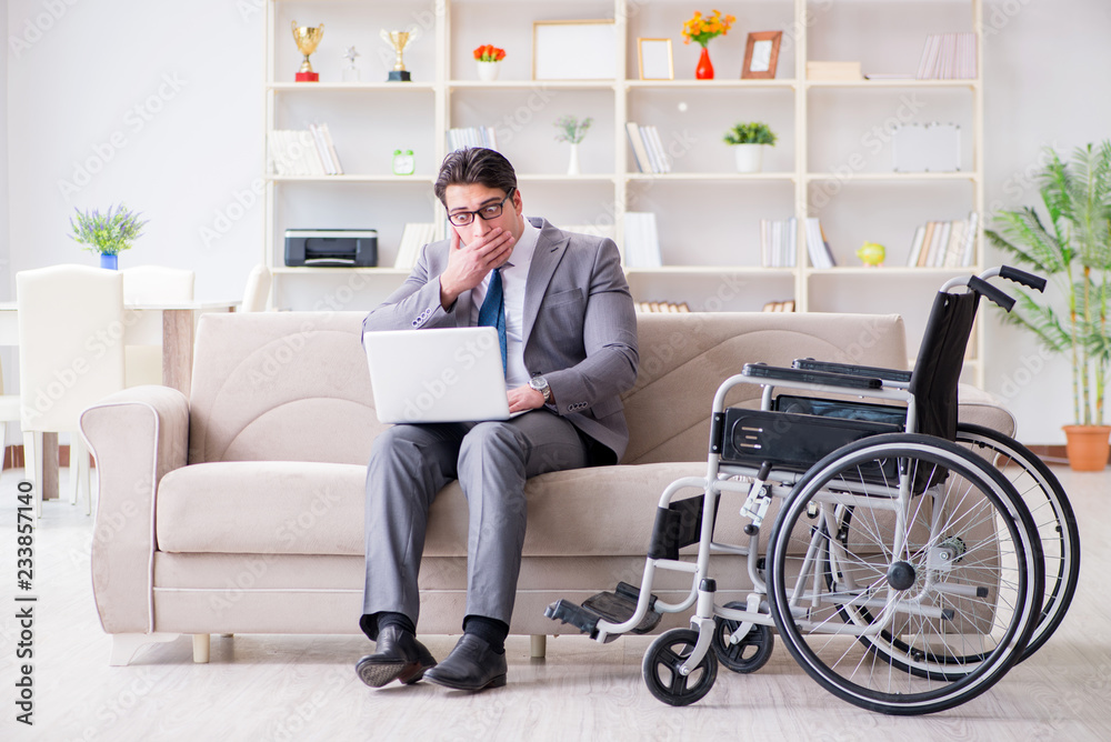 Dsabled businessman on wheelchair working home Dsabled businessman on wheelchair working home