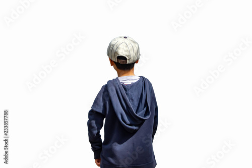 A boy wearing a winter jacket and hat standing on the white background.
