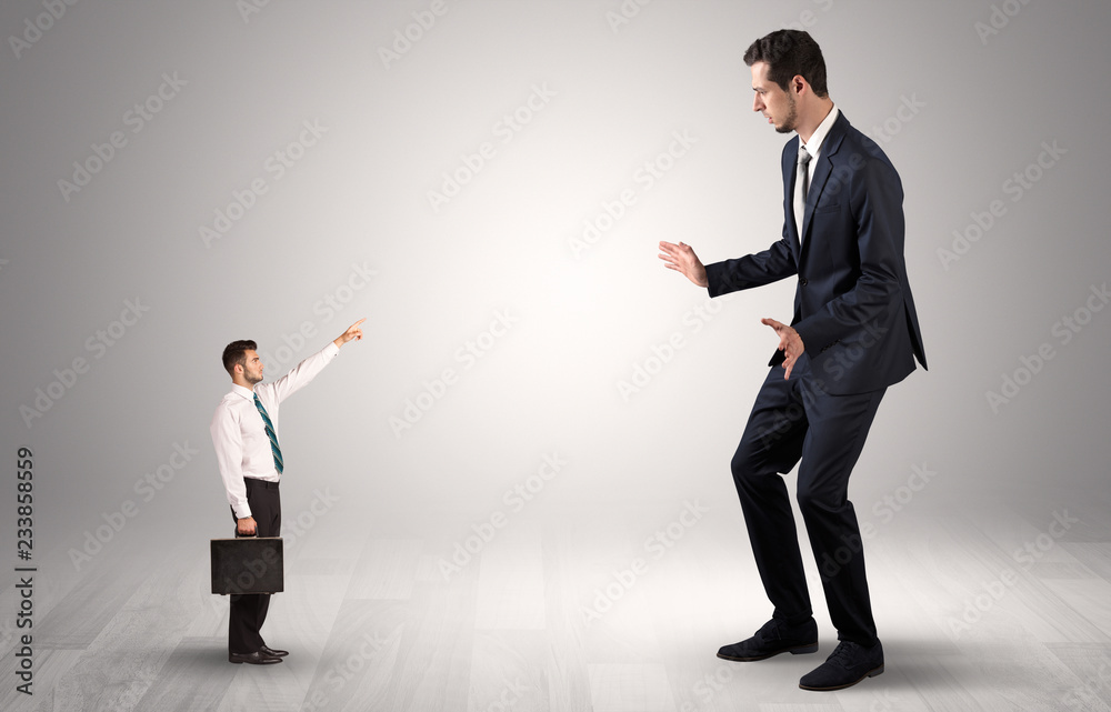 Small businessman in shirt pointing to an afraid businessman
Small businessman in shirt pointing to an afraid businessman