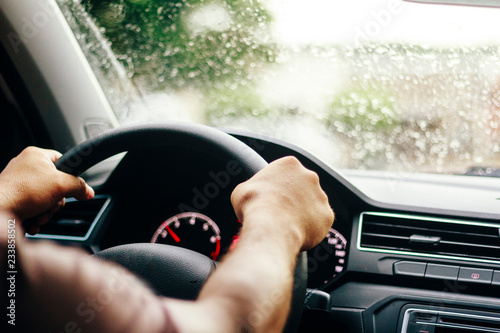 Driver driving car safely on rainy day