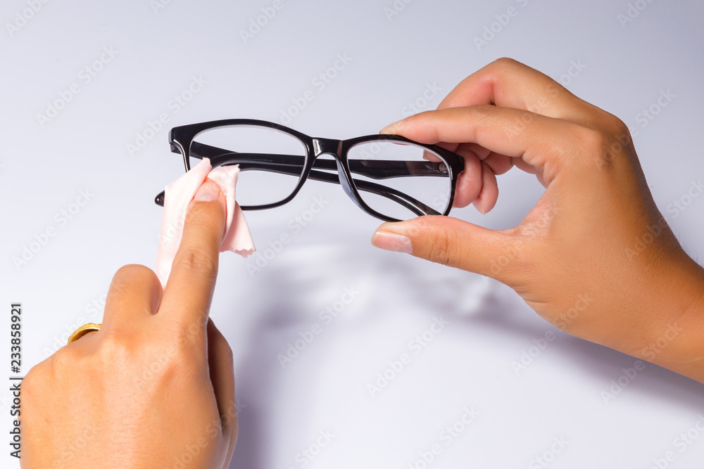 Man holding the black eye glasses spectacles with shiny black frame isolated on white Man holding the black eye glasses spectacles with shiny black frame isolated on white