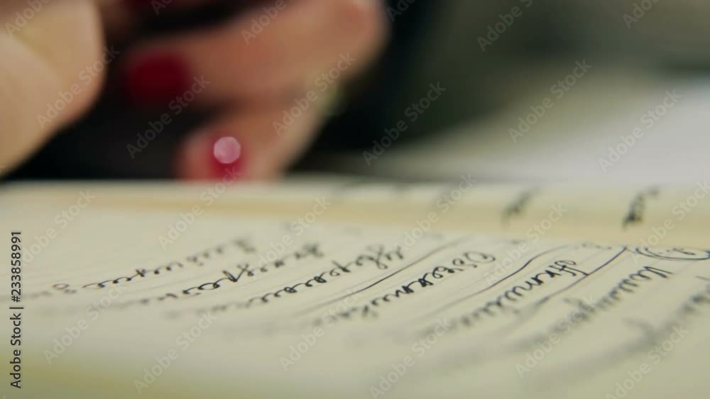 Woman writes a pen in daily Woman writes a pen in daily
