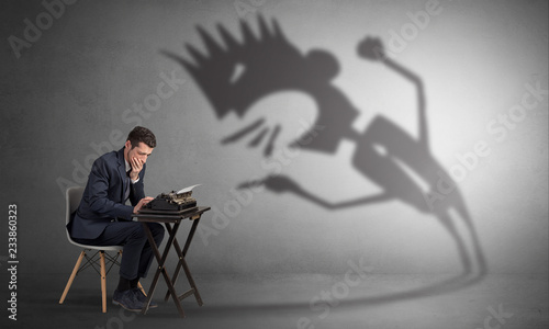 Man working hard and he is afraid of a yelling shadow

