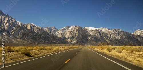 Driving Iconic California State Highway 395 in Owens Valley on Eastern Flanks of Sierra Nevada Mountains with Distant Mount Whitney on Horizon photo