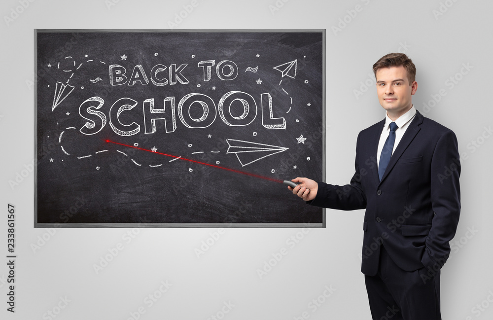 Handsome young teacher with laser pointer teaching 
