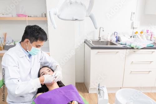 Dentist checking patient woman teeth