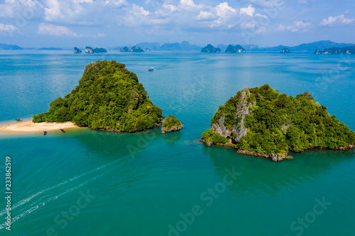Aerial drone view of an exotic, tiny tropical island with sandy beach and jungle © whitcomberd