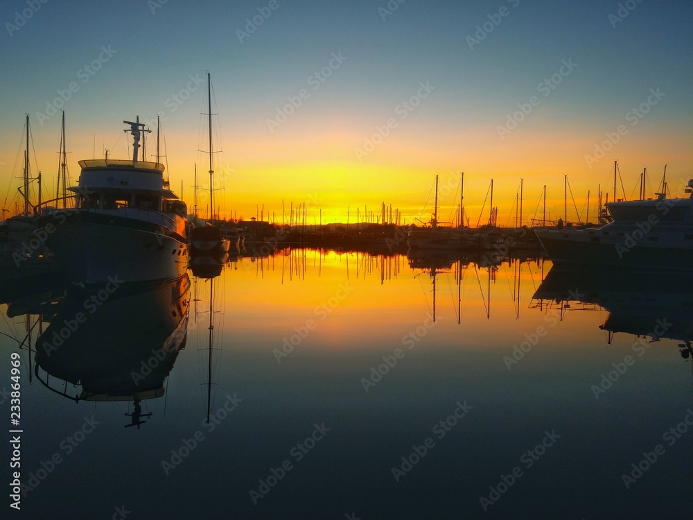 Fototapeta premium Beautiful boat silhouette in quiet harbor