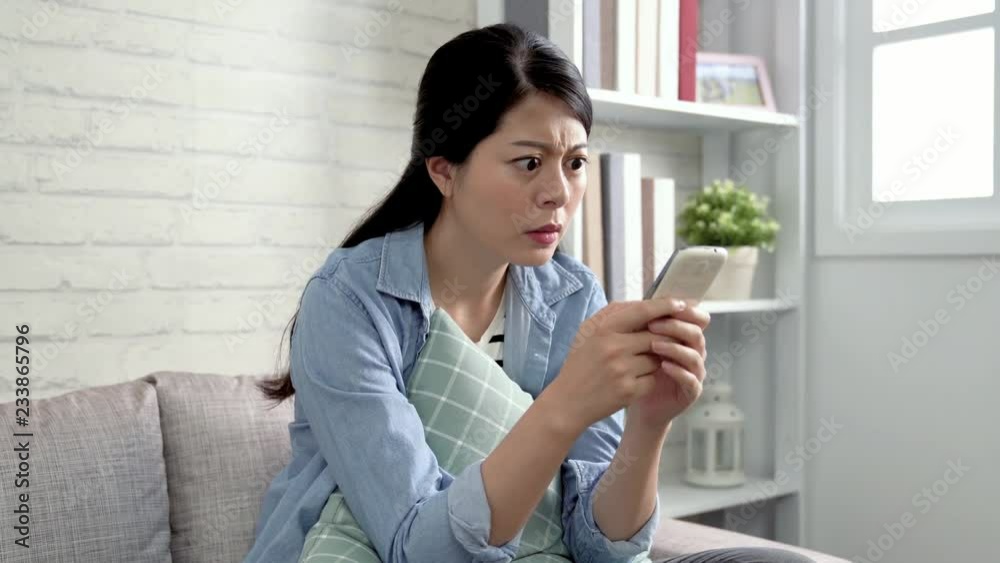 asian lady putting phone away after received the message from stupid boyfriend. young girl angry about the news on cellphone and walked to her room. woman struggle with annoying husband. asian lady putting phone away after received the message from stupid boyfriend. young girl angry about the news on cellphone and walked to her room. woman struggle with annoying husband.