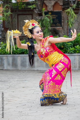 Beautiful dancer performing traditional Balinese dance photo