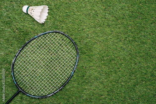 Badminton racket on the green , top view