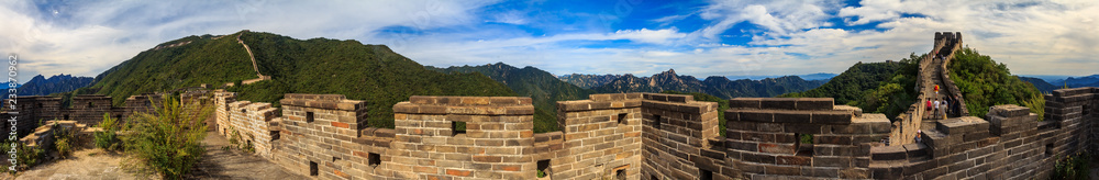 Panoramic view of the Great Wall of China and tourists walking on the wall in the Mutianyu village a remote part of the Great Wall near Beijing