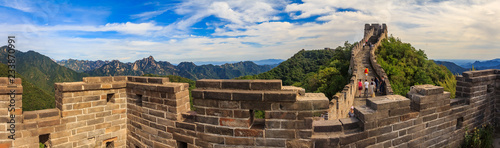 Panoramic view of the Great Wall of China and tourists walking on the wall in the Mutianyu village a remote part of the Great Wall near Beijing photo