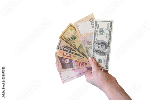 Banknotes of different countries and denominations fan in hand.