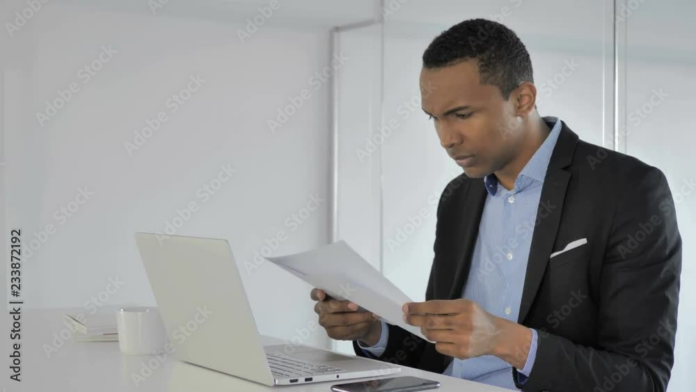 Upset Casual Afro-American Businessman Reacting to Fail Contract Report, Reading Upset Casual Afro-American Businessman Reacting to Fail Contract Report, Reading