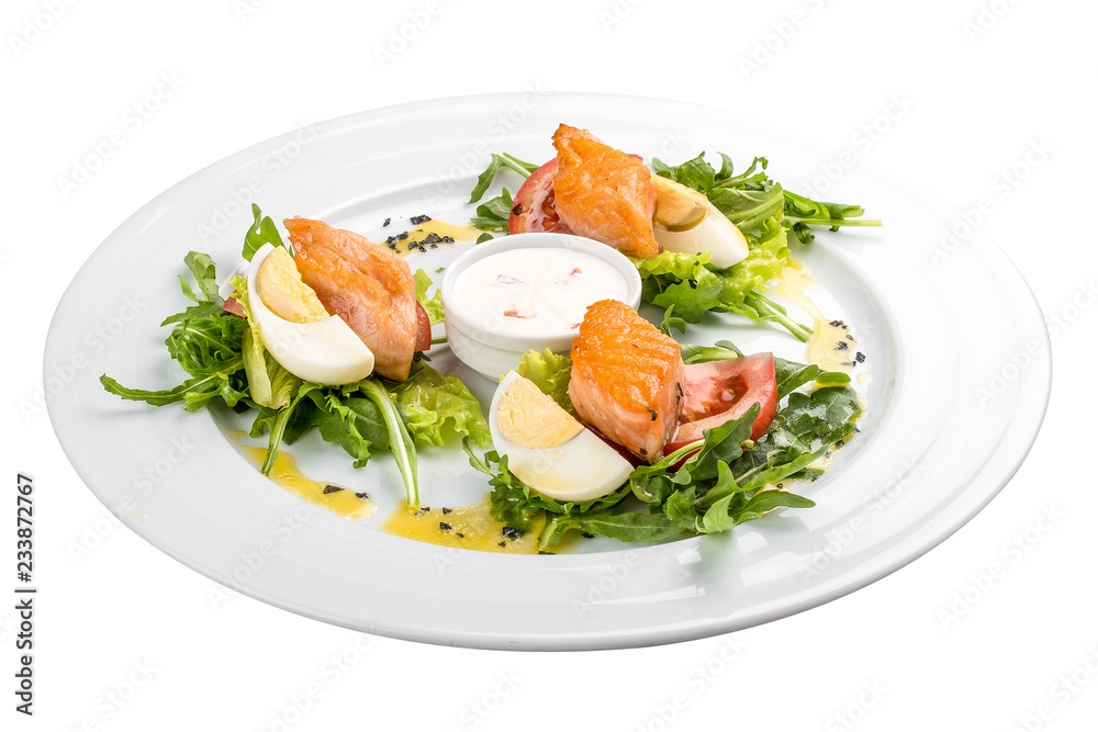 Salad with baked salmon in olive oil with tomatoes and egg