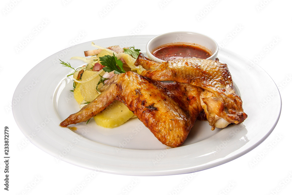 Fried chicken wings with potatoes on a white background