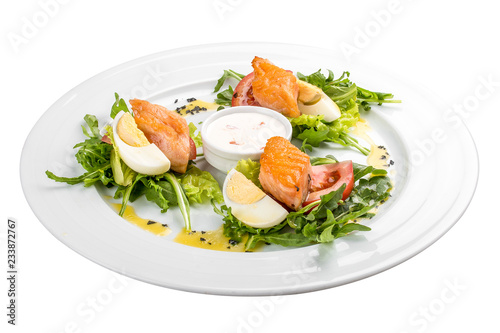 Salad with baked salmon in olive oil with tomatoes and egg