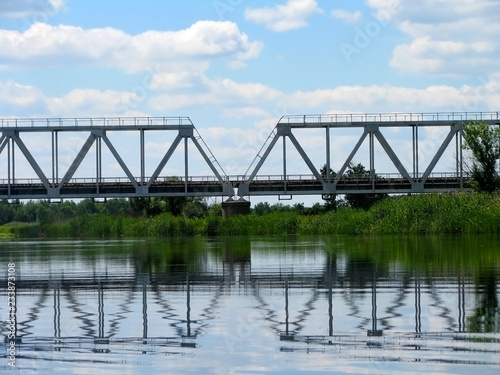 railway bridge over the river on the background of nature