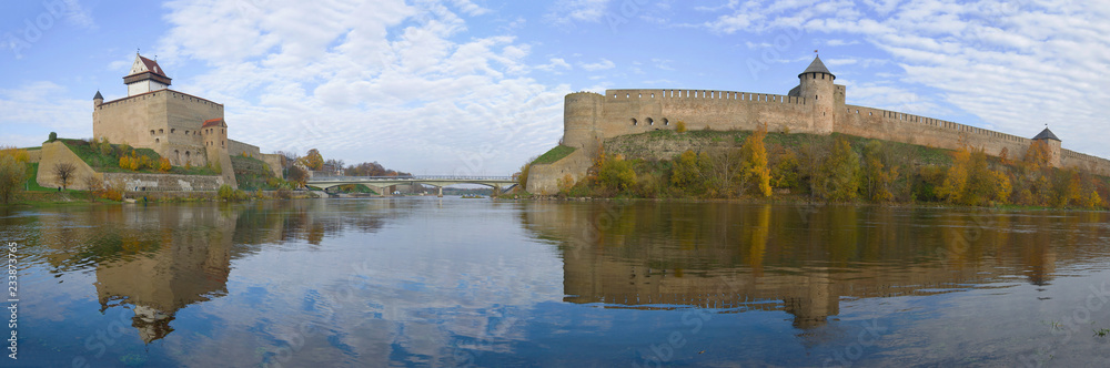 Panorama of the border river Narva in the golden autumn. Border of Estonia and Russia