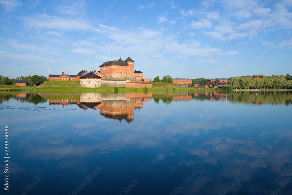 Fototapeta premium Panorama of Vanajavesi lake overlooking the ancient fortress of Hameenlinna on a sunny July morning. Finland