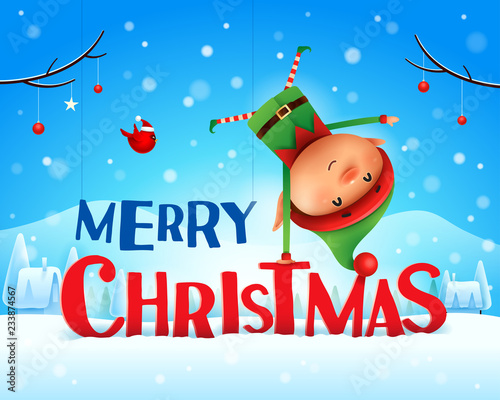 Merry Christmas! Little elf standing on his arm in Christmas snow scene winter landscape.