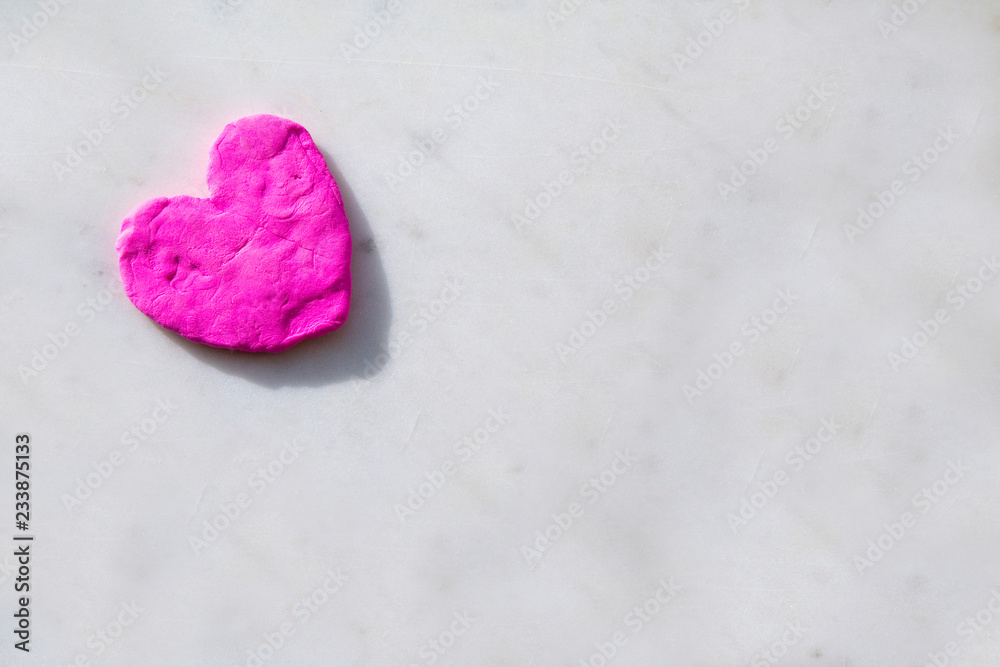 heart from plasticine on a light background, a symbol of love, copy space