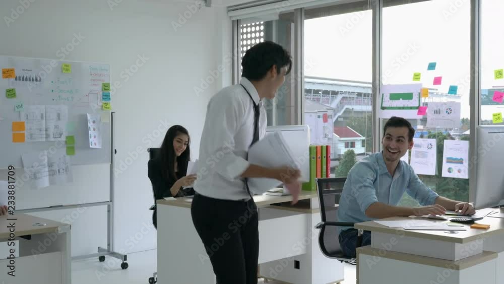 Businessman working with desktop and feeling excited. Business man throwing report paper with delight. Concept of business success. Businessman working with desktop and feeling excited. Business man throwing report paper with delight. Concept of business success.