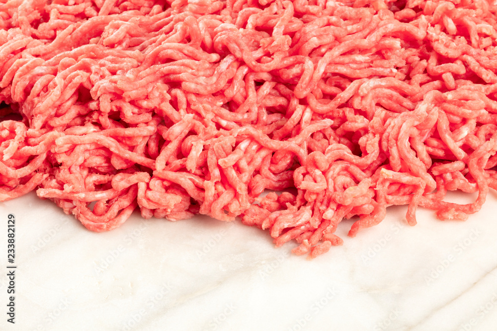 A photo of minced meat on a white marble background with a place for text A photo of minced meat on a white marble background with a place for text