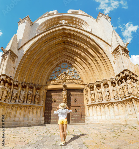 Happy young tourist woman at the Tarragona Cathedral, One of most famous places in Catalonia, Spain